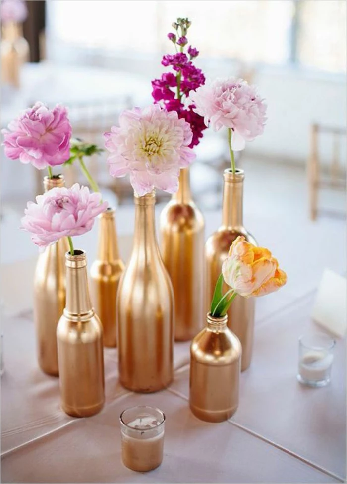 glass bottles, painted in gold, spring flower in each one, dining table centerpiece ideas, small candles
