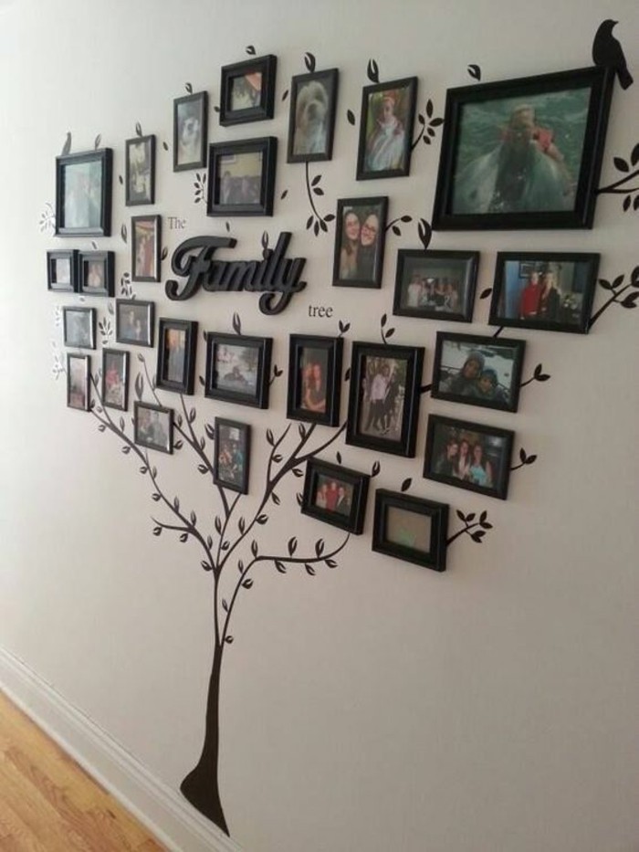 family tree, black framed photos, arranged in the shape of a tree, hanging wall decor, on a white wall
