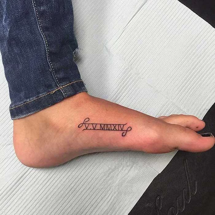foot tattoo, infinity symbols, roman numeral wrist tattoo, white paper