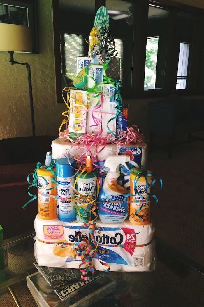 what is a good housewarming gift, tower made of cleaning products, toilet paper, tissues and soap