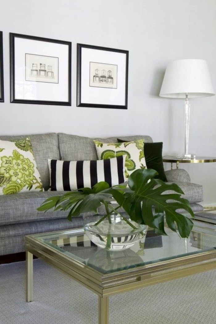 glass coffee table, grey sofa, green floral, throw pillows, what colors match with grey, framed hanging art