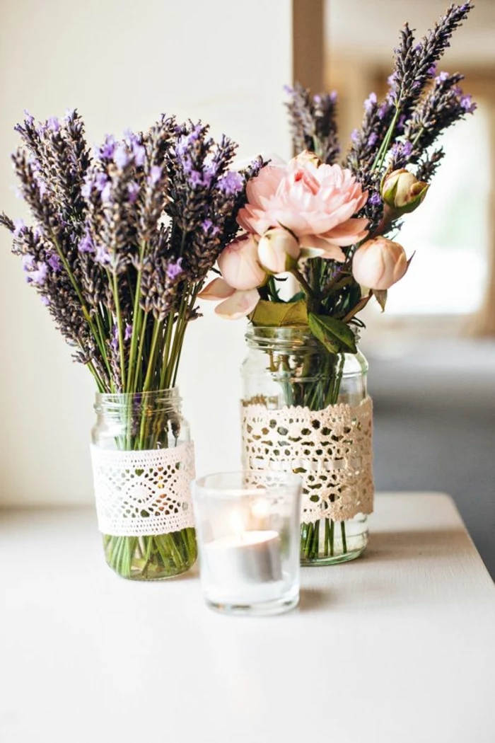 two glass jars, lavender bouquet, flowers and lavender bouquet, kitchen table decor, wooden table
