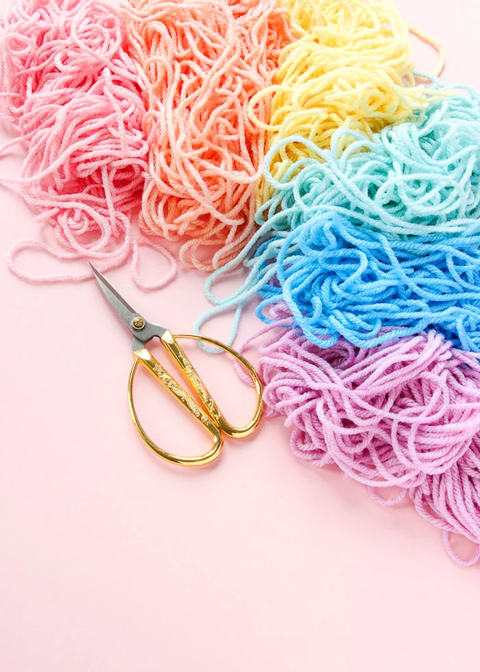 colourful yarn, pink background, cute gifts for boyfriend, pair of scissors, step by step, diy tutorial