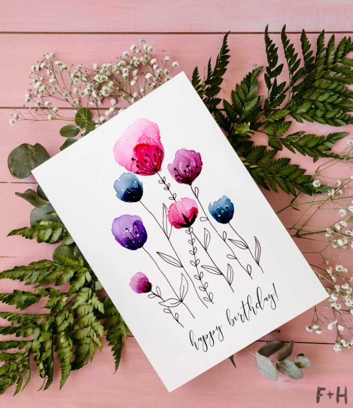 diy birthday cards, watercolour flowers, painted on a white card stock, greenery, on a pink background