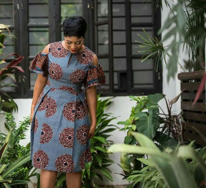 african attire for women, short dress, short black hair, lots of greenery around