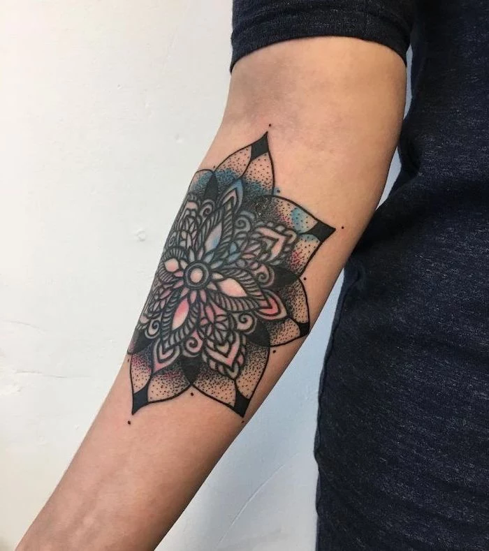 colourful forearm tattoo, white background, mandala symbols, grey top