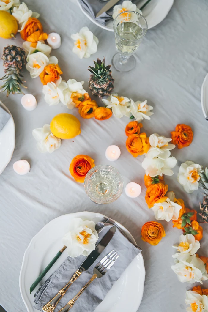 dining table decoration, white and orange flowers, table runner, grey cotton napkins, table setting