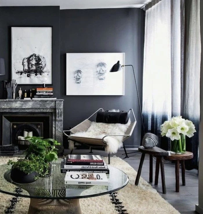 framed hanging art, above the fireplace, glass coffee table, dark grey walls, grey color schemes
