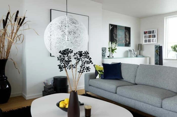 grey sofa, white walls, gray and white living room, white coffee table, black vase, wooden floor