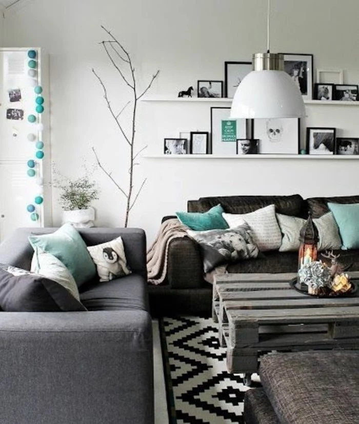 grey and black sofas, turquoise throw pillows, wooden pallet coffee table, accent colors for gray