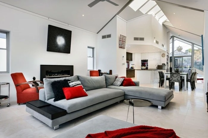 colors that go with gray walls, grey corner sofa, red throw pillows, a shaped ceiling, red armchair