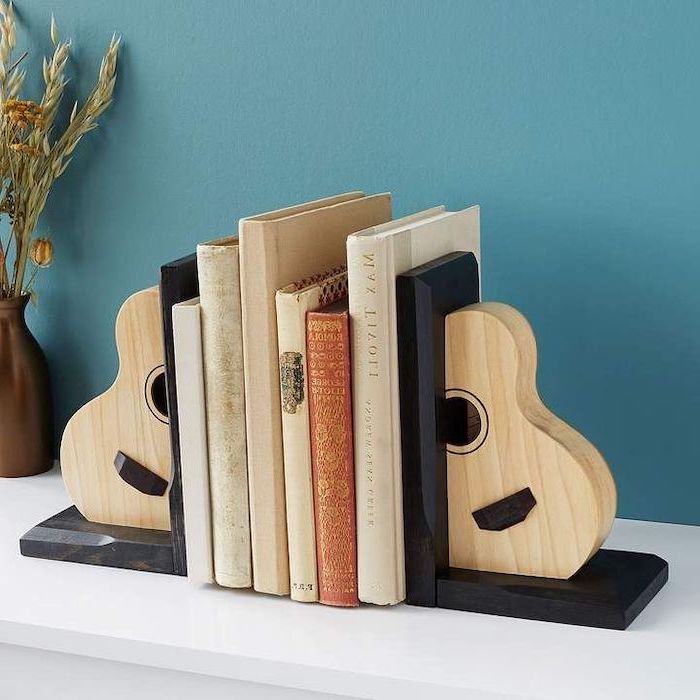 guitar book stoppers, set of books, practical housewarming gifts, blue wall in the background