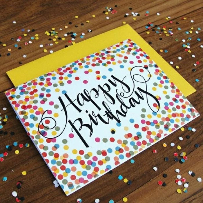 colourful confetti, drawn on white card stock, cool birthday cards, yellow envelope, wooden table