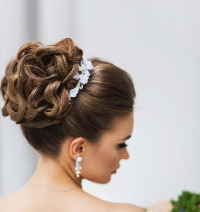 brown hair, in a high updo, floral hair accessory, easy hairstyles for girls, white hanging earrings