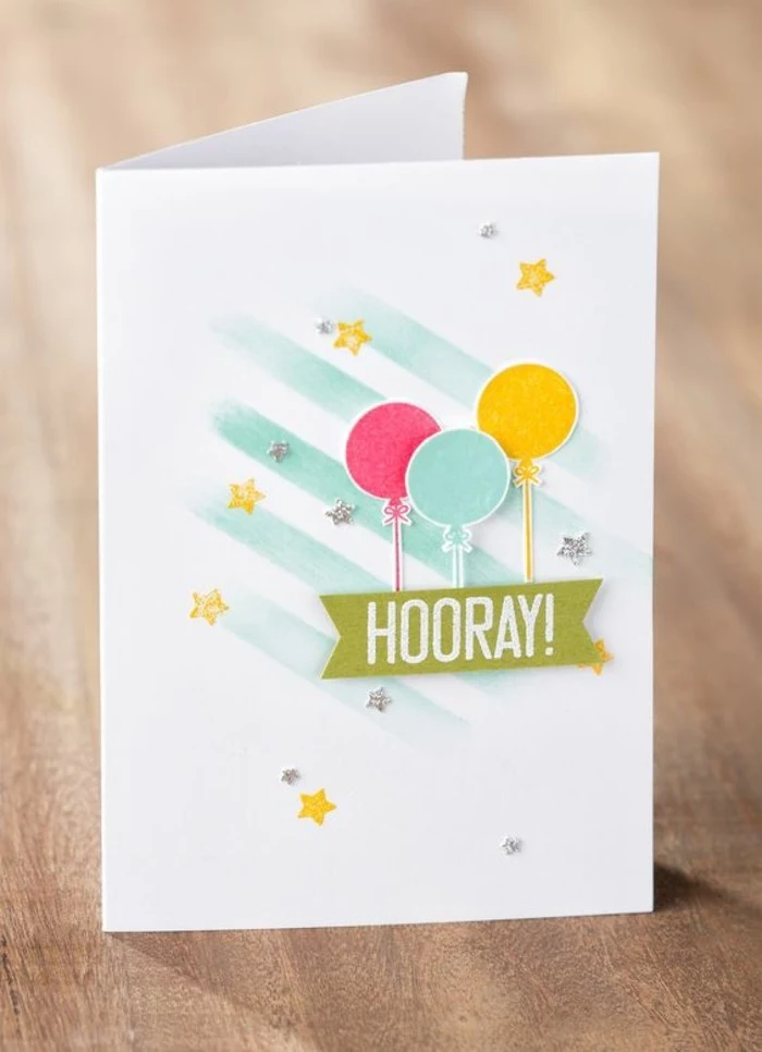 pink blue and yellow balloons, on white card stock, best birthday cards, wooden table