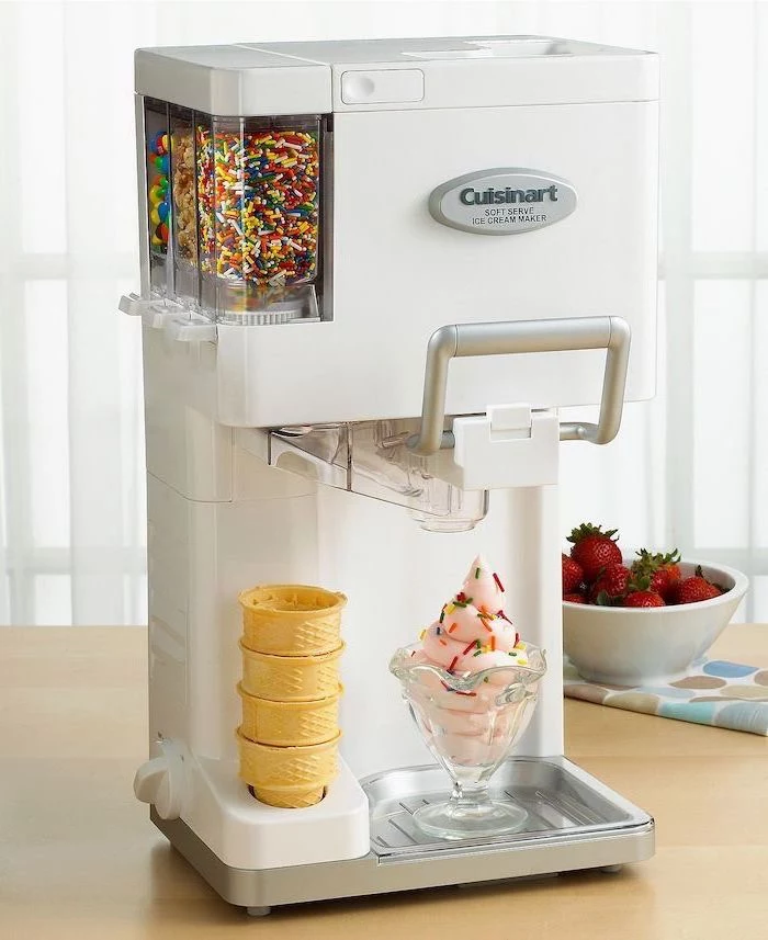 ice cream maker, with cones and sprinkles, practical housewarming gifts, wooden table, strawberries in a bowl