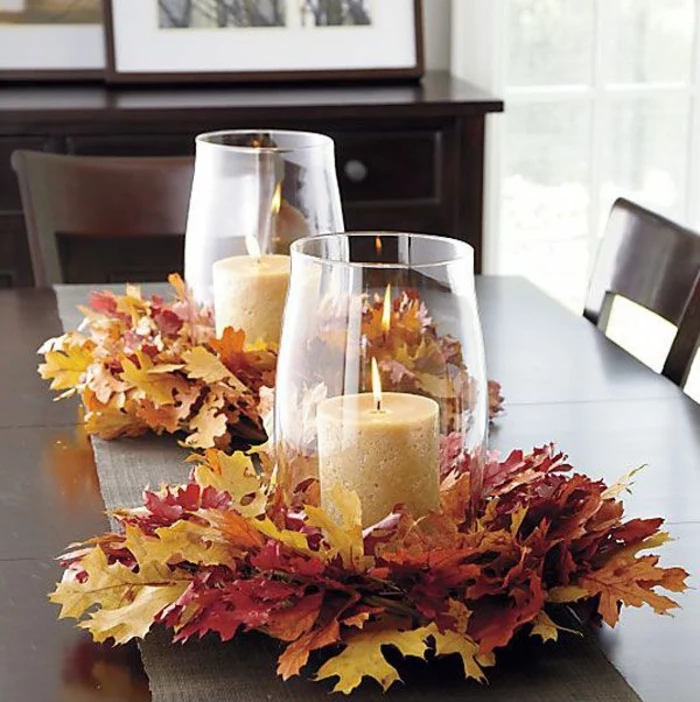 fallen leaves, large glass vases on top, candles inside, kitchen table decor, wooden table and chairs