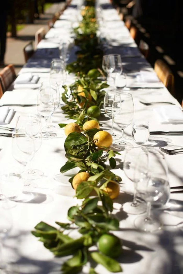 lemons and lemon tree branches, table runner, center table decor, wine glasses, table settings