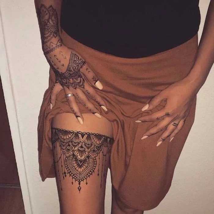 brown skirt, thigh tattoo, hand tattoo, mandala back tattoo, white background, black top