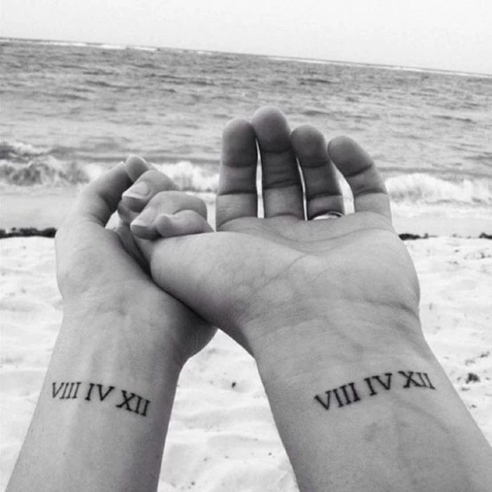 roman numerals translation, couples matching, wrist tattoo, ocean waves in the backgorund