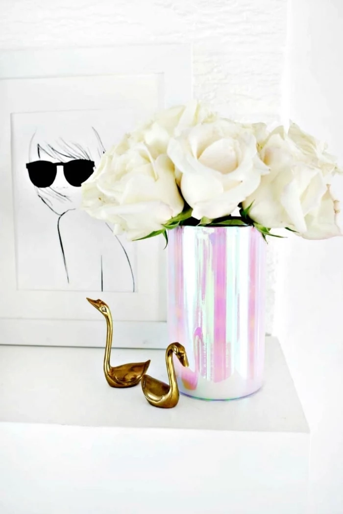 monochromatic vase, bouquet of white roses, table setting ideas, metal swan figurines, framed drawing
