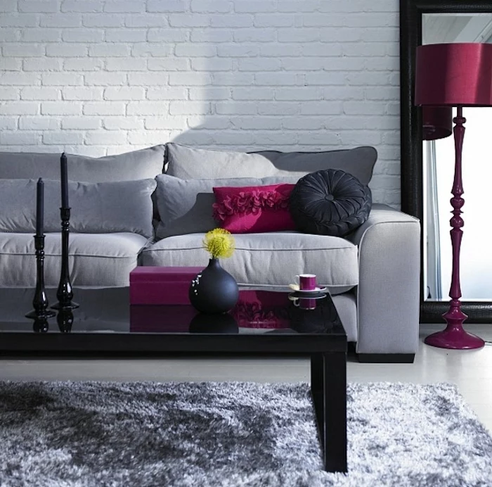 grey sofa, pink and black throw pillows, pink lamp stand, gray color schemes, black coffee table