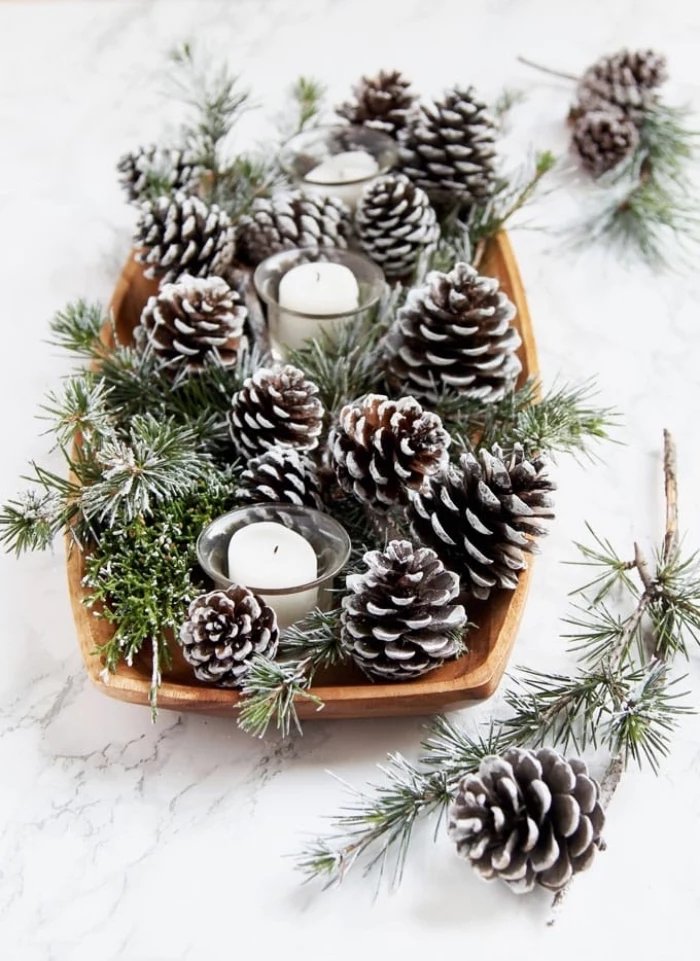 marble countertop, fall flower arrangements, wooden tray, full of pine cones, candles in candle holders
