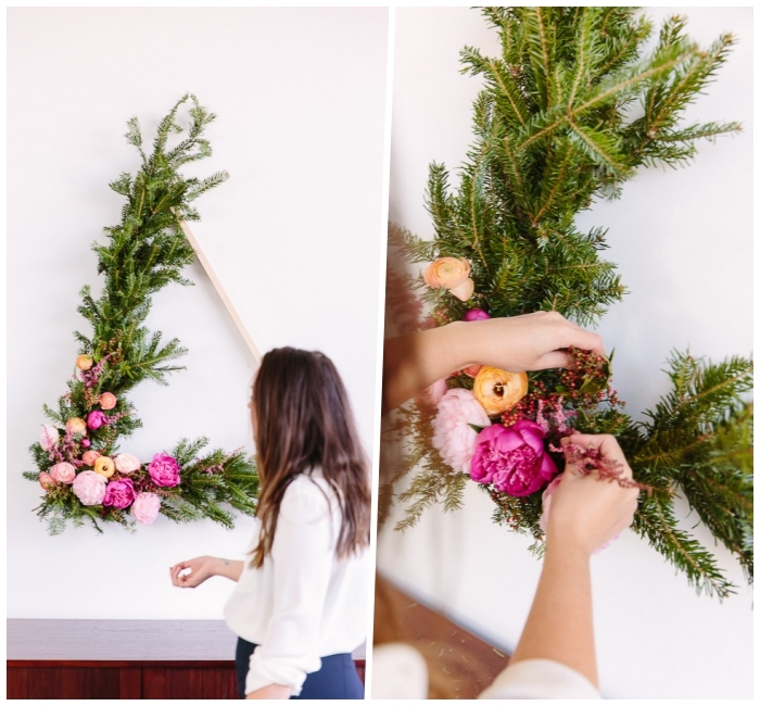 diy canvas art, wooden triangle, covered in pine tree branches, colourful flowers, hanging on a white wall
