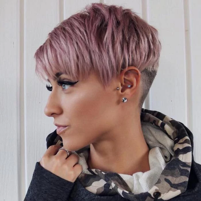 pink pixie cut, short to mid length hairstyles, navy hoodie, white background