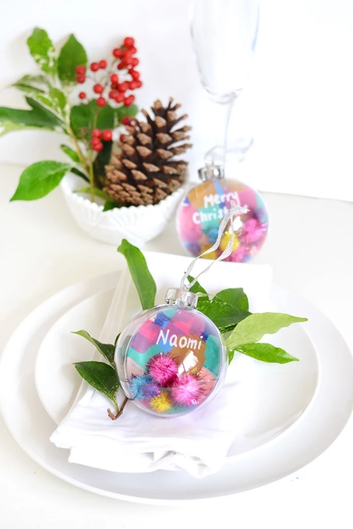 white plates, colourful baubles, dining table centerpieces, pine cone, tree branch, inside a bowl