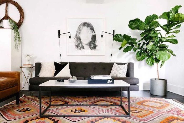 dark grey sofa, metal coffee table, marble countertop, small living room layout, printed carpet, hanging art