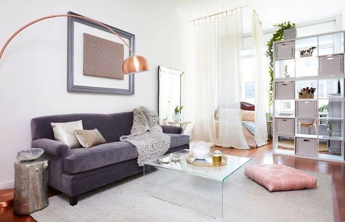 purple velvet sofa, small living room ideas, glass coffee table, white curtains, small wooden bookshelf