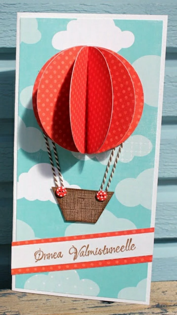 red hot air balloon, card making ideas, blue skies, blue wooden background, red and white strand