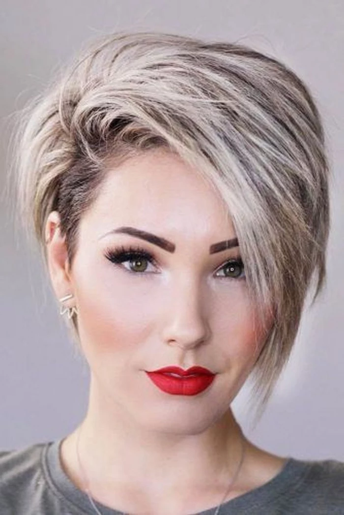 red lipstick, blonde hair, asymmetrical short hair, white background, grey shirt