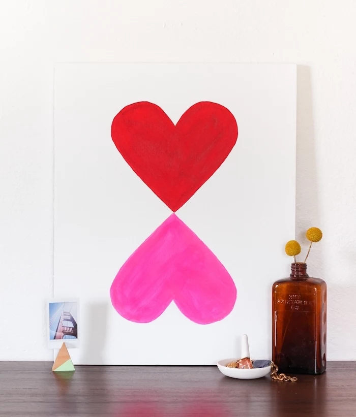 painting on a wooden table, diy wall art, pink and red heart, painted on a white canvas, mirror images
