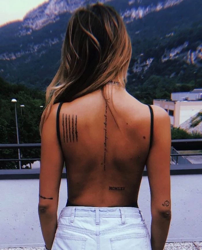 mountain landscape, back tattoo, roman numbers tattoo, white washed jeans