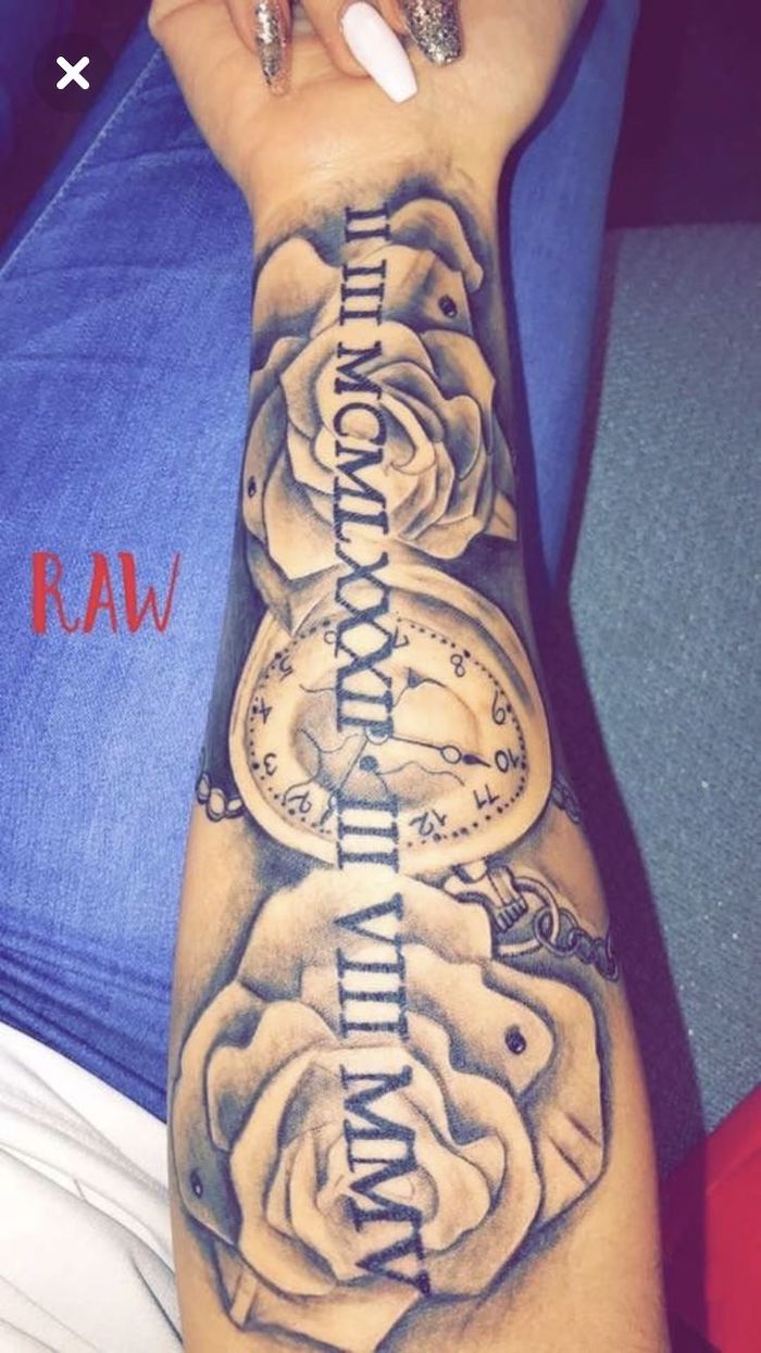 long nails, blue jeans, roses and a pocket watch, roman numeral tattoos on arm