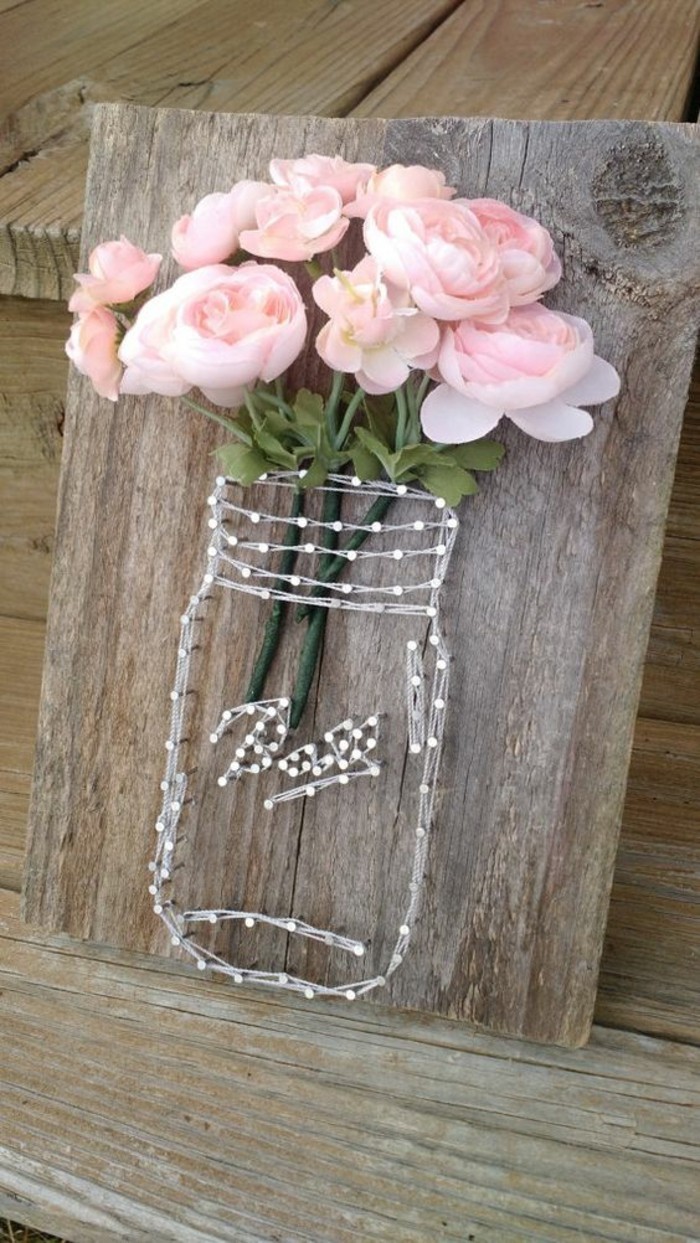 mason jar, formed of strings and nails, on a wooden block, diy decor ideas for bedroom, bouquet of roses
