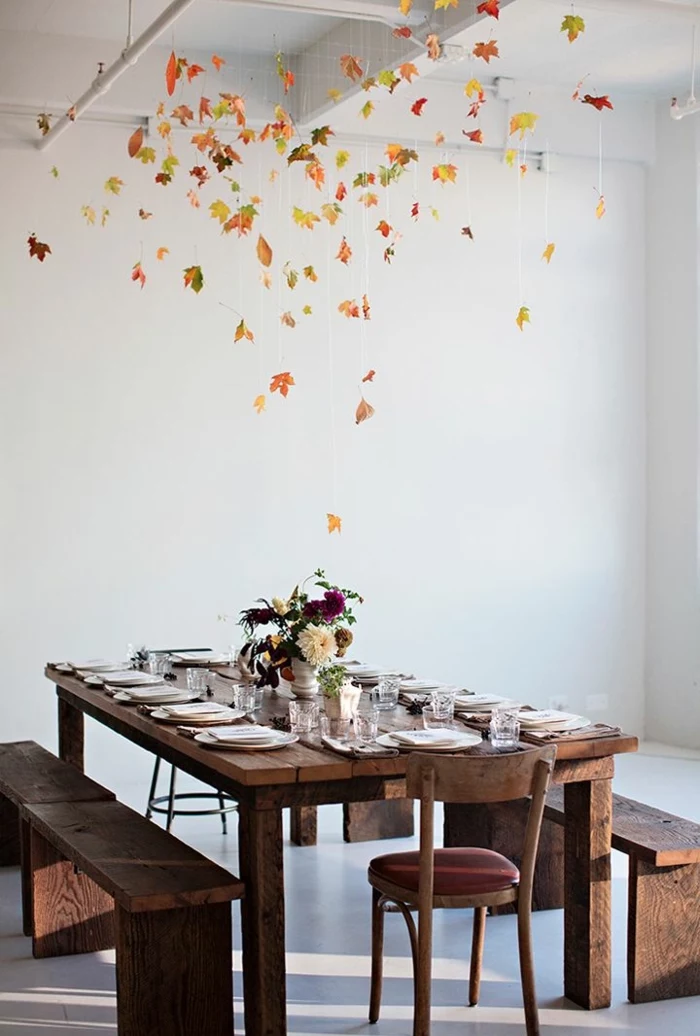 fallen leaves, hanging from the ceiling, wooden table and benches, flower bouquet, dining table decor ideas