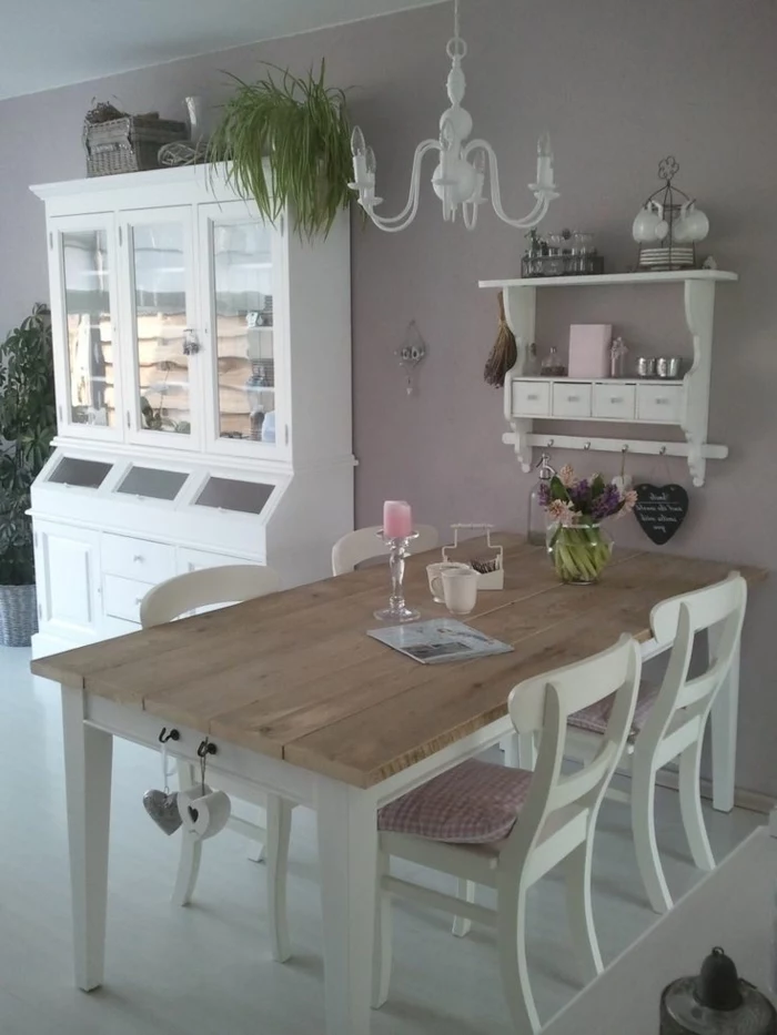 wooden table and chairs, dining table decor ideas, plastic candle holder, flower bouquet, purple walls