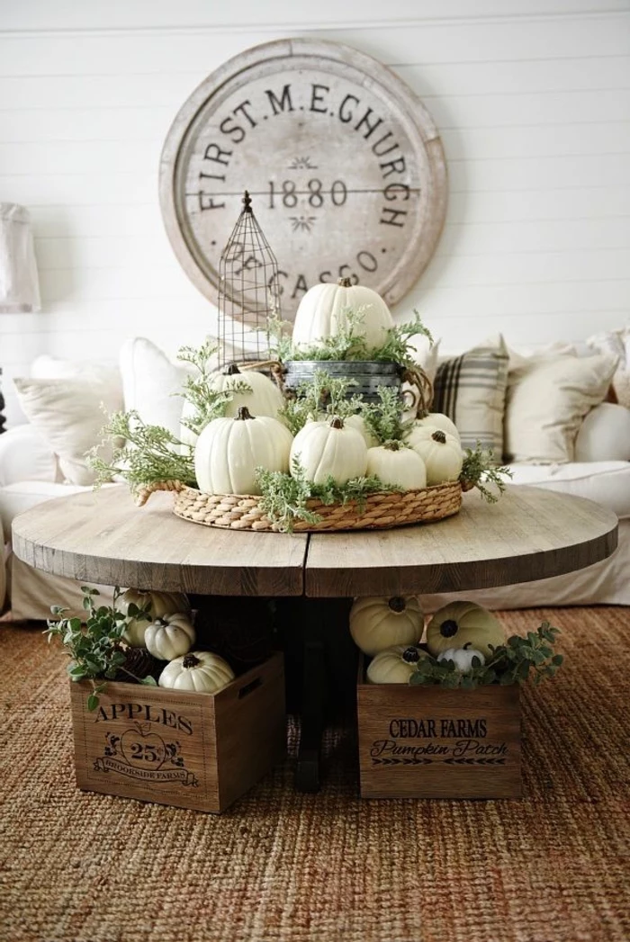 small round, wooden coffee table, wooden tray, full of white pumpkins, dining table decor ideas, wooden crates