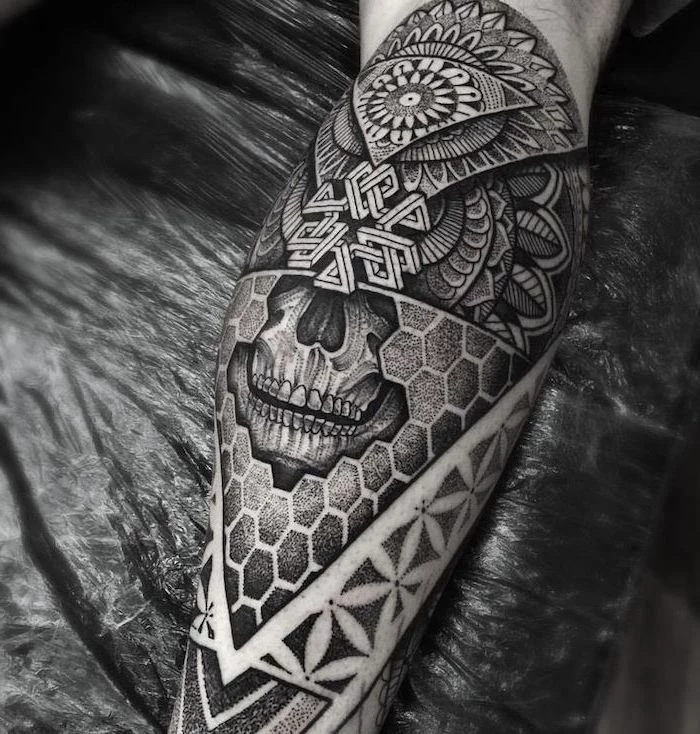 black background, skull leg tattoo, mandala thigh tattoo