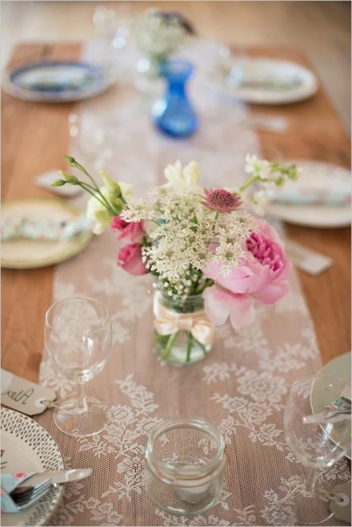 simple centerpieces, small glass jar, spring flower bouquet, white lace, table runner, table settings