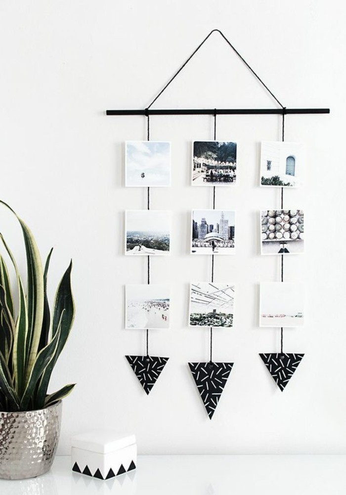 diy living room decor, black and white photos, hanging from a black metal pole, on a white wall