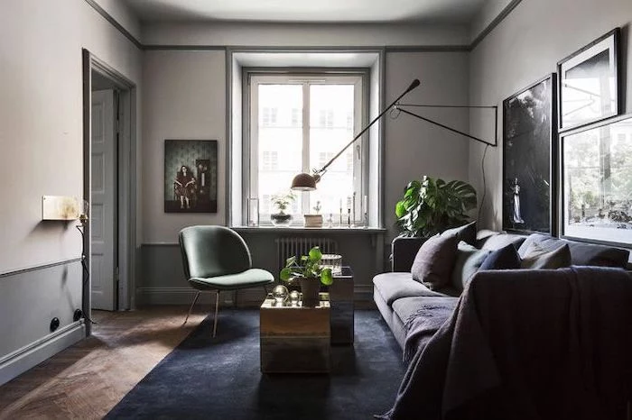 small apartment living room ideas, dark blue velvet carpet, grey sofa, green chair, metal coffee tables