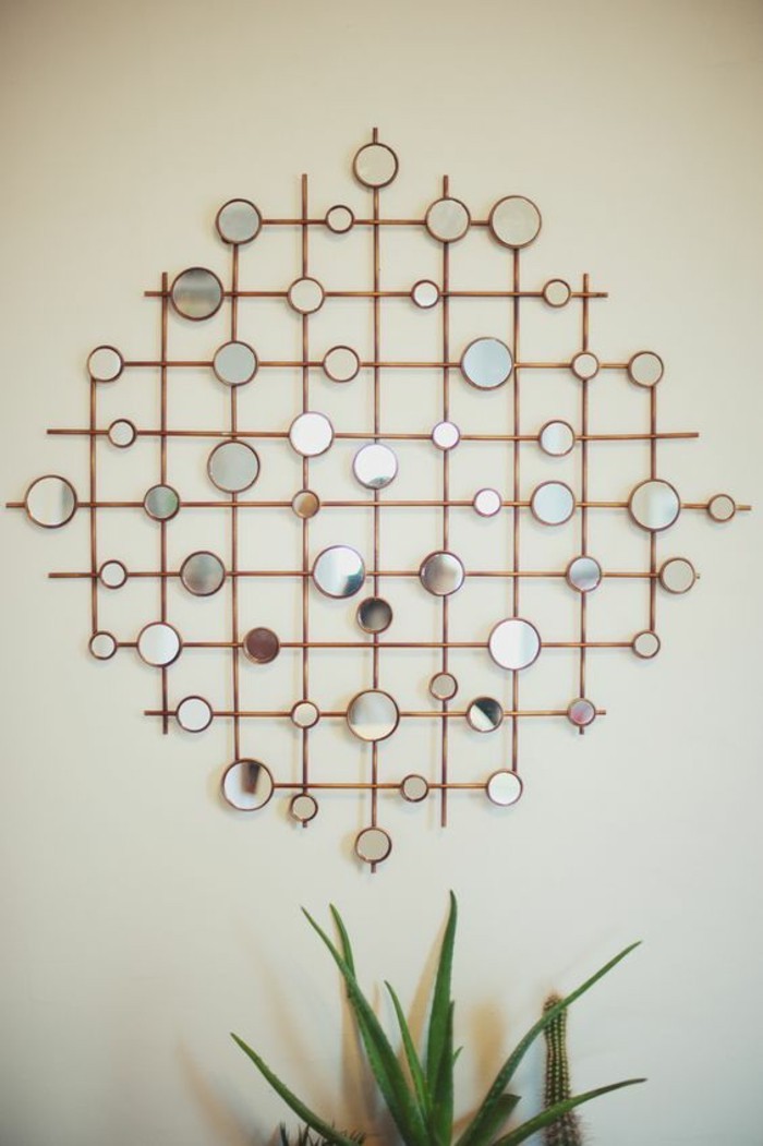 geometrical design, made of metal poles, small round mirrors, diy living room decor, on a white wall