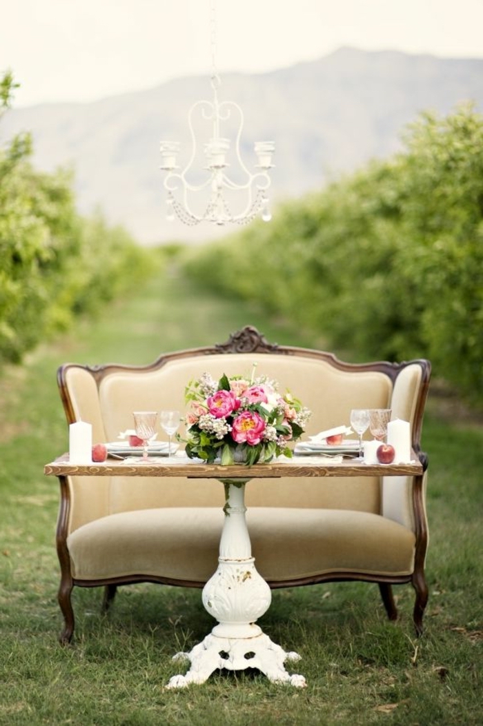 vintage wooden table, vintage sofa, simple centerpieces, large bouquet of flowers, in the middle