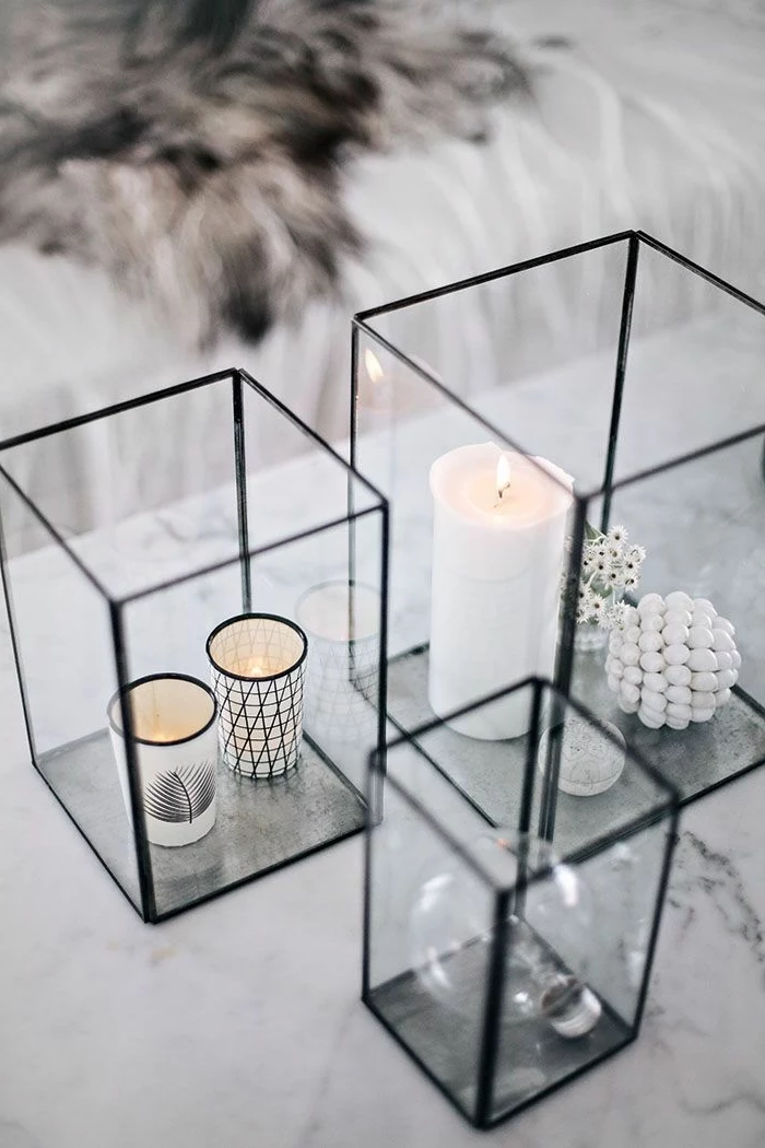 square glass aquariums, full of candles, on a marble countertop, simple centerpieces