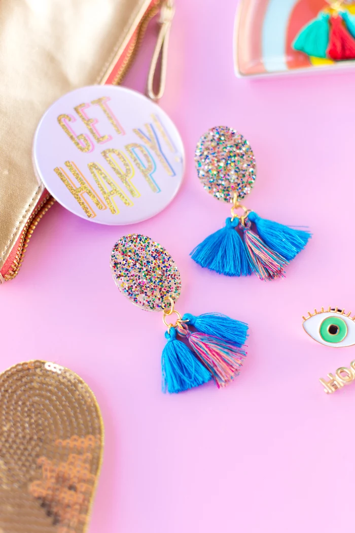 get happy badge, colourful tassel earrings, colourful glitter, creative gift ideas, pink background