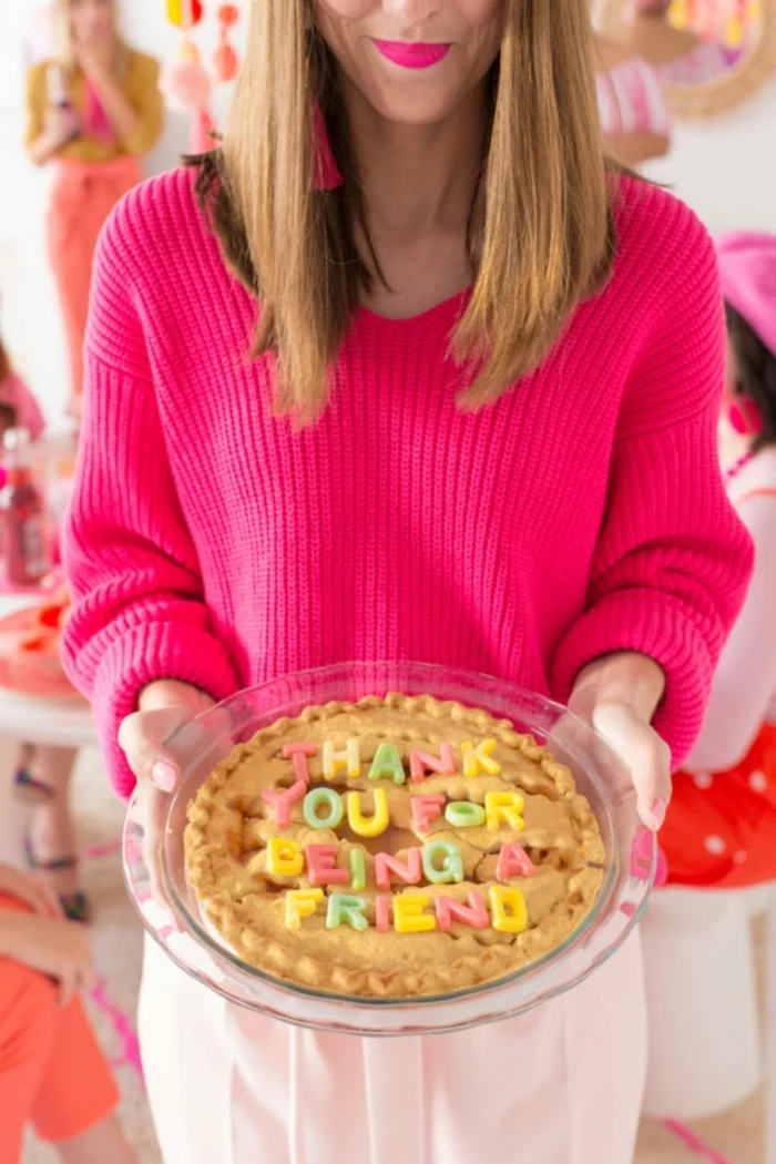 pink sweater, thank you for being a friend pie, diy christmas gifts for mom, woman holding a pie